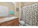 Bathroom features a single vanity with a shower with patterned curtain at 24723 Rio Villa Lakes Cir, Punta Gorda, FL 33950