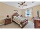 Serene bedroom with a lake view, ceiling fan, and classic furniture at 24723 Rio Villa Lakes Cir, Punta Gorda, FL 33950