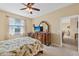 Charming bedroom featuring a dresser with TV, water view, and calming ambiance at 24723 Rio Villa Lakes Cir, Punta Gorda, FL 33950