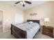 Bedroom showcases a ceiling fan and a decorative piece above the dark wood bed at 24723 Rio Villa Lakes Cir, Punta Gorda, FL 33950