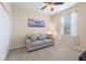 Bedroom features a couch, window and beach themed art at 24723 Rio Villa Lakes Cir, Punta Gorda, FL 33950