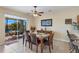 Dining area with tile floor, ceiling fan, table with six chairs, and sliding door to patio at 24723 Rio Villa Lakes Cir, Punta Gorda, FL 33950