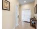 Open hallway featuring neutral wall paint, tile floors, and white doors at 24723 Rio Villa Lakes Cir, Punta Gorda, FL 33950