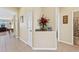 Inviting hallway with neutral walls, tile flooring, and decorative accents at 24723 Rio Villa Lakes Cir, Punta Gorda, FL 33950