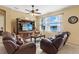Inviting living room with comfortable seating and scenic lake view through sheer-curtained windows at 24723 Rio Villa Lakes Cir, Punta Gorda, FL 33950