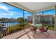 Screened-in patio with table and seating overlooking the serene lake at 24723 Rio Villa Lakes Cir, Punta Gorda, FL 33950