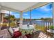 Screened-in lanai with a table and seating that has views of the lake at 24723 Rio Villa Lakes Cir, Punta Gorda, FL 33950