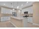 Modern kitchen featuring white cabinets, granite counters, and pendant lighting at 13164 Amaryllis Cir, Port Charlotte, FL 33981