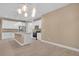 Spacious kitchen with white cabinets, granite island, and stylish lighting at 13164 Amaryllis Cir, Port Charlotte, FL 33981