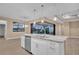 Kitchen island with granite countertop overlooks pool and lanai at 13164 Amaryllis Cir, Port Charlotte, FL 33981
