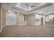 Open living room features a coffered ceiling, tile floors, and a view of the kitchen at 13164 Amaryllis Cir, Port Charlotte, FL 33981
