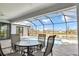 Enjoy dining in this screened patio enclosure with a view of the sparkling pool at 13164 Amaryllis Cir, Port Charlotte, FL 33981