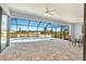 Spacious screened pool enclosure with patio furniture and view of the pool at 13164 Amaryllis Cir, Port Charlotte, FL 33981