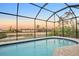 Relaxing pool at sunset, screened enclosure offers privacy at 13164 Amaryllis Cir, Port Charlotte, FL 33981