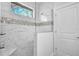 Modern shower with marble tile and glass enclosure at 13164 Amaryllis Cir, Port Charlotte, FL 33981