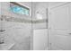 Walk-in shower with marble tile and built-in seat at 13164 Amaryllis Cir, Port Charlotte, FL 33981