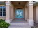 Front entry with double teal doors and tile flooring at 2615 Rio Plato Dr, Punta Gorda, FL 33950