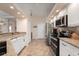 Well-equipped kitchen with granite countertops and white cabinets at 2615 Rio Plato Dr, Punta Gorda, FL 33950