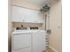 Laundry room with washer, dryer, and overhead storage at 2615 Rio Plato Dr, Punta Gorda, FL 33950