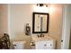 Bathroom with white vanity, framed mirror, and decorative towels at 956 Harbor Town Dr, Venice, FL 34292
