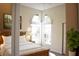 Bright bedroom features a large window, wood floors, a queen bed, neutral walls, and a plant at 956 Harbor Town Dr, Venice, FL 34292
