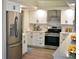 Modern kitchen features stainless steel appliances, white cabinets, light countertops, and modern hardware at 956 Harbor Town Dr, Venice, FL 34292