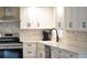 Close up of kitchen features stainless steel appliances, white cabinets, and modern fixtures at 956 Harbor Town Dr, Venice, FL 34292