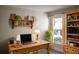 Home office featuring a wooden desk, bookshelves, and natural light at 956 Harbor Town Dr, Venice, FL 34292