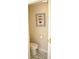 Small powder room with toilet and nautical-themed art at 956 Harbor Town Dr, Venice, FL 34292