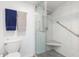 Bathroom with walk-in shower, grab bars, and marble-tiled walls at 175 Kings Hwy # 718, Punta Gorda, FL 33983