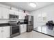 Modern kitchen with white cabinets, stainless steel appliances, and granite countertops at 175 Kings Hwy # 718, Punta Gorda, FL 33983