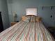 Bedroom with striped bedding and a small nightstand at 5524 Holiday Park Blvd, North Port, FL 34287