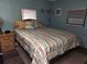 Spacious bedroom with striped bedding and wood floors at 5524 Holiday Park Blvd, North Port, FL 34287