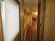 Long hallway with light wood laminate floors at 5524 Holiday Park Blvd, North Port, FL 34287