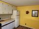 Bright kitchen with white cabinets and yellow walls at 5524 Holiday Park Blvd, North Port, FL 34287