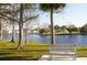 Serene waterfront view with a peaceful bench at 5524 Holiday Park Blvd, North Port, FL 34287