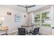 Spacious home office with a large desk, two chairs, and a window at 1051 Adalia Ter, Port Charlotte, FL 33953