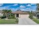 One-story home with attached garage, landscaping, and a spacious driveway at 632 Rose Apple Cir, Port Charlotte, FL 33954
