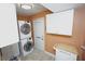 Laundry room with washer, dryer, and storage cabinets at 1 Colony Point Dr # B9, Punta Gorda, FL 33950