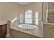 Bathroom with a large garden tub and window at 17152 Wintergarden Ave, Port Charlotte, FL 33948