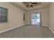 Spacious bedroom with carpeting, ceiling fan, and sliding door to patio at 17152 Wintergarden Ave, Port Charlotte, FL 33948