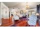 Bright living room with hardwood floors, comfortable seating, and elegant chandelier at 240 Divinci Dr, Punta Gorda, FL 33950