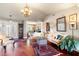 Spacious living room featuring hardwood floors, a chandelier, and ample natural light at 240 Divinci Dr, Punta Gorda, FL 33950