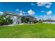 Landscaped backyard with pool and canal views at 1457 Sea Fan Dr, Punta Gorda, FL 33950