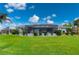 Landscaped backyard with pool and screened enclosure at 1457 Sea Fan Dr, Punta Gorda, FL 33950