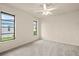 Bright bedroom with carpet flooring, ceiling fan, and large windows at 1457 Sea Fan Dr, Punta Gorda, FL 33950