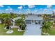 Single-story home with tile roof, landscaping, and driveway at 1457 Sea Fan Dr, Punta Gorda, FL 33950