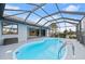 Enclosed kidney-shaped pool with a glass roof at 1457 Sea Fan Dr, Punta Gorda, FL 33950