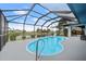Relaxing kidney-shaped pool with a screened enclosure at 1457 Sea Fan Dr, Punta Gorda, FL 33950