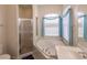 Bathroom with a garden tub, shower, and a window with blue curtains at 2970 Royal Palm Dr, North Port, FL 34288